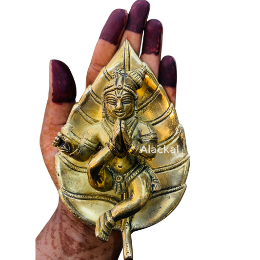 BRASS WALL-HANGING BABY KRISHNA WITH FLUTE LYING ON A BANYAN LEAF