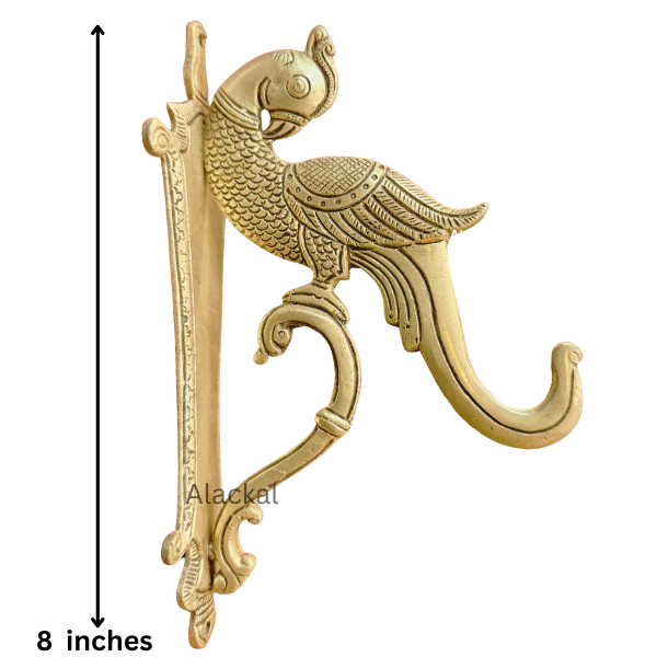 Decorative brass peacock wall hook mounted on a living room wall in a modern USA home – premium solid brass wall mount hook from Alackal Bell Metals Mannar