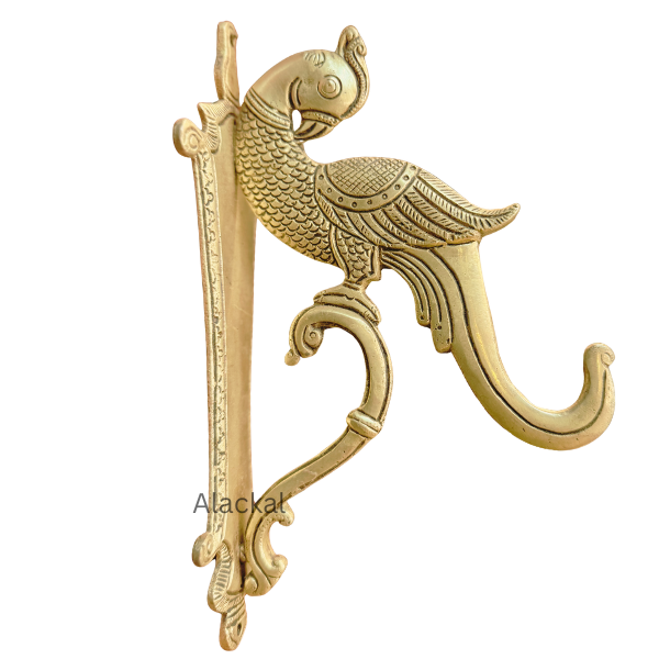 Decorative brass peacock wall hook mounted on a living room wall in a modern USA home – premium solid brass wall mount hook from Alackal Bell Metals Mannar 